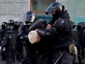Police officers detain a man in St. Petersburg on Sept. 24, 2022, following calls to protest against the partial mobilization announced by the Russian president.