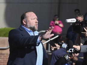 Alex Jones speaks to the media before entering court for the Sandy Hook defamation damages trial at Connecticut Superior Court in Waterbury, Conn., Tuesday, Sept. 20, 2022.