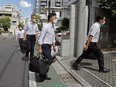 Officers of the Tokyo District Public Prosecutors Office enter to search the headquarters of publisher Kadokawa Corp in Tokyo, Japan in this photo taken by Kyodo on September 6, 2022.