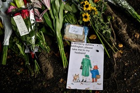 A drawing of Queen Elizabeth II and Paddington Bear is pictured next to a marmalade sandwich on a makeshift tribute by Buckingham Palace in London on Sept. 15, 2022.
