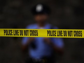 Tape cordons off the scene where multiple people were shot near a high school in Philadelphia, Tuesday, Sept. 27, 2022.