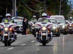 A procession of police vehicles escort the body of slain Toronto Police Const. Andrew Hong from the Ontario Coroner’s office in Toronto, to the Kane-Jerrett Funeral home on Yonge Street in Richmond Hill, on  September 14, 2022.