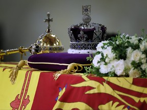 The coffin of Queen Elizabeth II, draped in the Royal Standard with the Imperial State Crown and the Sovereign's orb and sceptre, lying in state on the catafalque at Westminster Hall on Sept. 17, 2022 in London.
