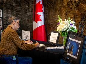Adnan Nayab signs a book of condolences for Queen Elizabeth II at city hall in Toronto, Ont. on Friday, Sept. 9, 2022.