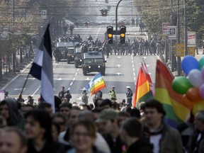 Serbian riot police gather to protect a gay pride parade as it moves along a street in Belgrade, Serbia, Sunday, Oct. 10, 2010.