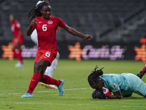 Trinidad and Tobago's goalkeeper Kimira Forbes catches the ball as Canada's Deanne Rose looks on during a CONCACAF Women's Championship soccer match in Monterrey, Mexico, Tuesday, July 5, 2022. Rose has been sidelined "for an extended period: after suffering an Achilles injury playing for Reading FC in its season opener in its Barclays Women's Super League season opener.