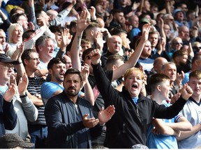 Soccer Football - Premier League - Wolverhampton Wanderers v Manchester City - Molineux Stadium, Wolverhampton, Britain - September 17, 2022
Manchester City fans applaud on seventy minutes following the death of Britain's Queen Elizabeth