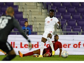 Canada's Alphonso Davies in action with Qatar's Ro-Ro on Sept.  23 in Vienna, Austria.  Lisa Leutner/Reuters