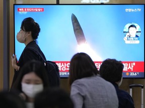 A TV screen shows a file image of a North Korean missile launch during a news program at the Seoul Railway Station in Seoul, South Korea, Wednesday, Sept. 28, 2022.