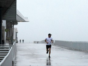 Residents exercise at the St. Pete pier as the first winds of Hurricane Ian arrive on September 28, 2022 in Saint Petersburg, Fla.