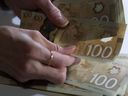 Canadian $100 bills are counted in Toronto, Feb. 2, 2016.