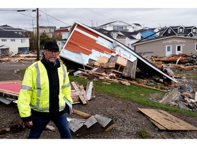 Port Aux Basques Mayor Brian Button walks through the town examining damage after the arrival of Hurricane Fiona in Port Aux Basques, Newfoundland, Sept. 25, 2022.
