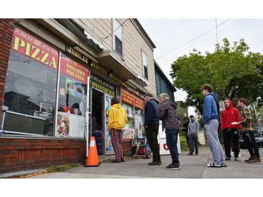 University students line up for food due at the generator-powered Jubilee Junction Covenience Store following the passing of Hurricane Fiona, later downgraded to a post-tropical storm, in south end Halifax, Nova Scotia, Sept. 24, 2022.