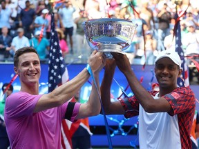 U.S. Open - Flushing Meadows, New York, United States - September 9, 2022
Rajeev Ram and Joe Salisbury of the U.S. celebrate with the trophy after winning their men's doubles final match against Netherland's Wesley Koolhof and Britain's Neal Skupski.