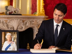 Prime Minister Justin Trudeau signs a book of condolence at Lancaster House following the death of Queen Elizabeth II, on September 17, 2022 in London, England.