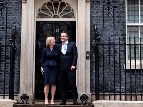 Standing outside 10 Downing Street, Britain's newly appointed Prime Minister Liz Truss poses for photographers with her husband Hugh O'Leary, after delivering her first speech as Prime Minister in central London, on Sept. 6, 2022.