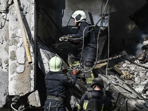 Firefighters extinguish a fire after a flat was hit by a missile strike in Bakhmut, Donetsk region, on September 15, 2022, amid the Russian invasion of Ukraine.