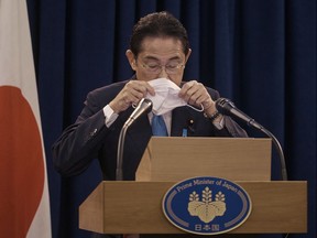 Prime Minister of Japan Fumio Kishida puts his mask on during a news conference on Thursday, Sept. 22, 2022 in New York.