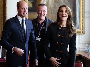 Prince William, Prince of Wales, and Catherine, Princess of Wales, laugh as they visit the Guildhall in Windsor on Sept. 22, 2022 to thank volunteers and staff who worked on the funeral of Queen Elizabeth II.