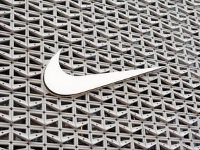 The Nike logo hangs above the entrance to the Nike store on December 21, 2021 in Miami Beach, Florida.
