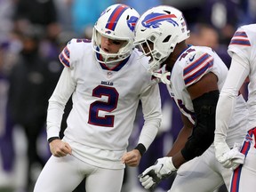 Tyler Bass #2 and Reggie Gilliam #41 of the Buffalo Bills celebrate after Bass kicked a field goal in the fourth quarter to beat the Baltimore Ravens.