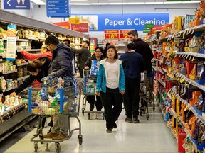 People shop at a Walmart Supercentre in Toronto, March 13, 2020.