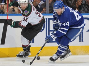 Morgan Rielly  of the Toronto Maple Leafs grabs a puck away from Christian Fischer  of the Arizona Coyotes during an NHL game at Scotiabank Arena on October 17, 2022 in Toronto. Rielly, the Leafs top defenceman, has been on the ice for seven even-strength goals against in four games, tied for most in the NHL.