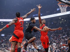 Raptors rookie Christian Koloko (right) goes up with O.G. Anunoby to defend against Darius Garland of the Cavaliers in Wednesday’s opener at Scotiabank Arena. The 7-foot-1 Koloko made an instant impact in his 14 minutes on the floor.