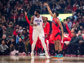 Raptors' Scottie Barnes makes a shot against Joel Embiid of the Philadelphia 76ers during the first half at Scotiabank Arena on Wednesday, Oct. 26, 2022 in Toronto.