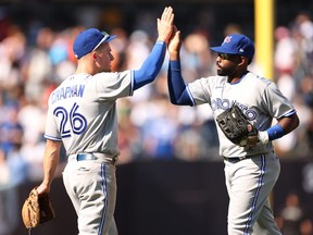 Matt Chapman high-fives Jackie Bradley Jr. of the Toronto Blue Jays after the ninth inning against the New York Yankees at Yankee Stadium on August 20, 2022 in the Bronx borough of New York City. The Blue Jays won 5-2.