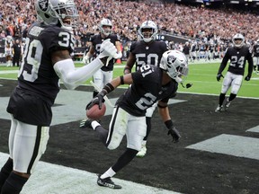 Cornerback Amik Robertson #21 of the Las Vegas Raiders celebrates with teammates after he returned a recovered fumble 68 yards for a touchdown against the Denver Broncos in the second quarter of their game at Allegiant Stadium on October 02, 2022 in Las Vegas, Nevada. The Raiders defeated the Broncos 32-23.