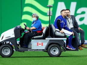 George Springer of the Toronto Blue Jays is carted of the field after colliding with Bo Bichette against the Seattle Mariners during the eighth inning in game two of the American League Wild Card Series at Rogers Centre on October 08, 2022 in Toronto, Ontario.