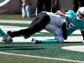 Sauce Gardner of the New York Jets tackles Teddy Bridgewater of the Miami Dolphins in the endzone for a safety during the first quarter at MetLife Stadium on Oct. 9, 2022 in East Rutherford, N.J.
