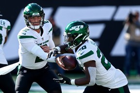 Zach Wilson of the New York Jets hands the ball to Breece Hall in the game against the Miami Dolphins at MetLife Stadium on Oct. 9, 2022 in East Rutherford, N.J. EDWARD DILLER/GETTY IMAGES