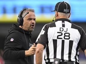 Head coach Matt Rhule of the Carolina Panthers talks with down judge Mark Hittner during the second quarter against the San Francisco 49ers at Bank of America Stadium on October 09, 2022 in Charlotte, North Carolina.