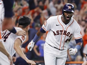 Yordan Alvarez of the Houston Astros celebrates after hitting a walk-off home run against the Seattle Mariners during the ninth inning in game one of the American League Division Series at Minute Maid Park on October 11, 2022 in Houston, Texas.