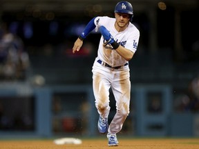 Trea Turner of the Los Angeles Dodgers runs home to score in the third inning during game one of the National League Division Series against the San Diego Padres at Dodger Stadium on October 11, 2022 in Los Angeles, California.