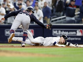 Josh Donaldson #28 of the New York Yankees gets tagged out at first base by Josh Naylor #22 of the Cleveland Guardians during the fifth inning in game one of the American League Division Series at Yankee Stadium on October 11, 2022 in New York, New York.