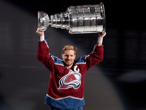 Gabriel Landeskog #92 of the Colorado Avalanche skates with the Stanley Cup at a ceremony  celebrating their NHL Championship before their home opener against the Chicago Blackhawks at Ball Arena on October 12, 2022 in Denver, Colorado.