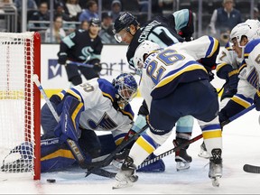Jaden Schwartz #17 of the Seattle Kraken watches the puck sail wide of Jordan Binnington #50 of the St. Louis Blues during the second period at Climate Pledge Arena on October 19, 2022 in Seattle, Washington.