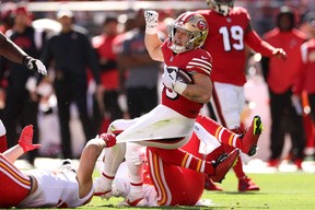Christian McCaffrey of the San Francisco 49ers gets dragged to the turf by the Kansas City Chiefsat Levi’s Stadium on October 23, 2022 in Santa Clara, California. ( Ezra Shaw/Getty Images)