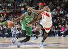 Boston Celtics’ Jaylen Brown gets by Toronto Raptors’ Precious Achiuwa.