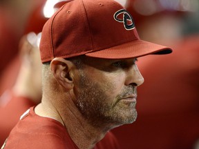 Manager Kirk Gibson  of the Arizona Diamondbacks looks on from the bench against the Baltimore Orioles at Chase Field on August 14, 2013 in Phoenix, Arizona.