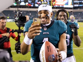 Philadelphia Eagles quarterback Jalen Hurts (1) celebrates with a game ball after a victory against the Dallas Cowboys at Lincoln Financial Field.