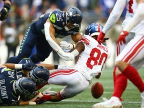 Richie James of the New York Giants fumbles a punt return against the Seattle Seahawks.