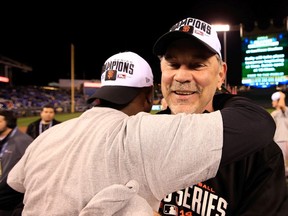 Manager Bruce Bochy #15 of the San Francisco Giants celebrates on the field after defeating the Kansas City Royals 3-2 to win Game Seven of the 2014 World Series at Kauffman Stadium on October 29, 2014 in Kansas City, Missouri.