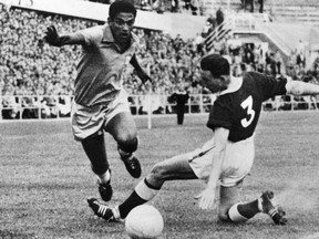 FILE: Brazilian footballer Garrincha (L) drives the ball past Mel Hopkins of Wales, during a quarter-final match of the FIFA World Cup in Goteborg, Sweden, on June 19, 1958.