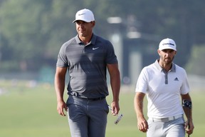 Brooks Koepka of the United States and Dustin Johnson of the United States walk off on the 18th green during the final round of the 2018 U.S. Open at Shinnecock Hills Golf Club on June 17, 2018 in Southampton, New York. (Photo by Rob Carr/Getty Images)