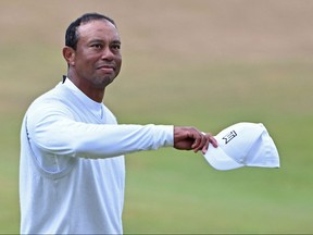 In this file photo taken on July 15, 2022 US golfer Tiger Woods gestures to the crowd on the 18th green at the end of his second round on day 2 of The 150th British Open Golf Championship on The Old Course at St Andrews in Scotland.