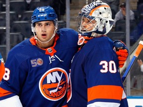 Alexander Romanov, left, and Ilya Sorokin of the New York Islanders celebrate their 3-1  victory over the New York Rangers at the UBS Arena on Oct. 8, 2022 in Elmont, N.Y.